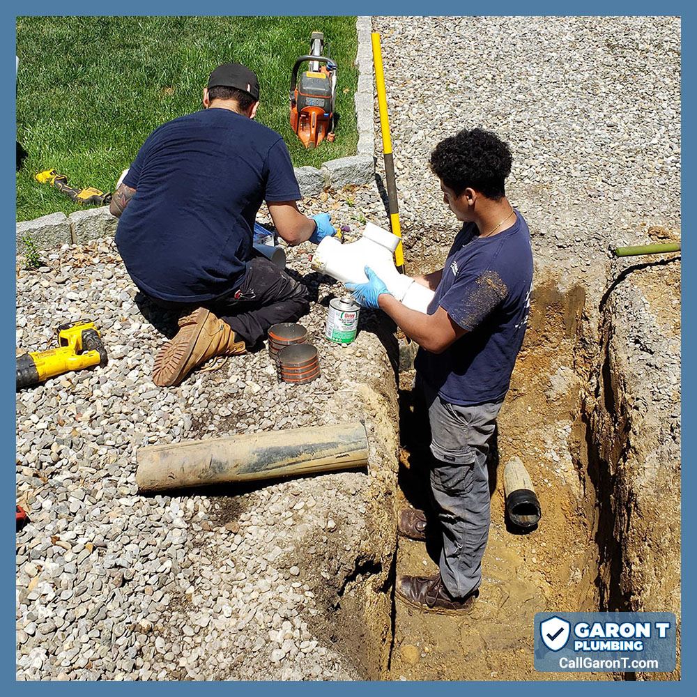 Garon T Technicians Bryan and Tim conducting trenchless sewer repair. Tim is kneeling on the left. Bryan is in the trench on the right.