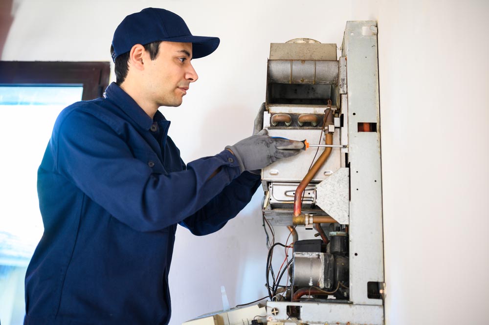 a technician installing a water heater