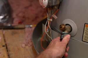 Garon T technician flushing a water heater tank